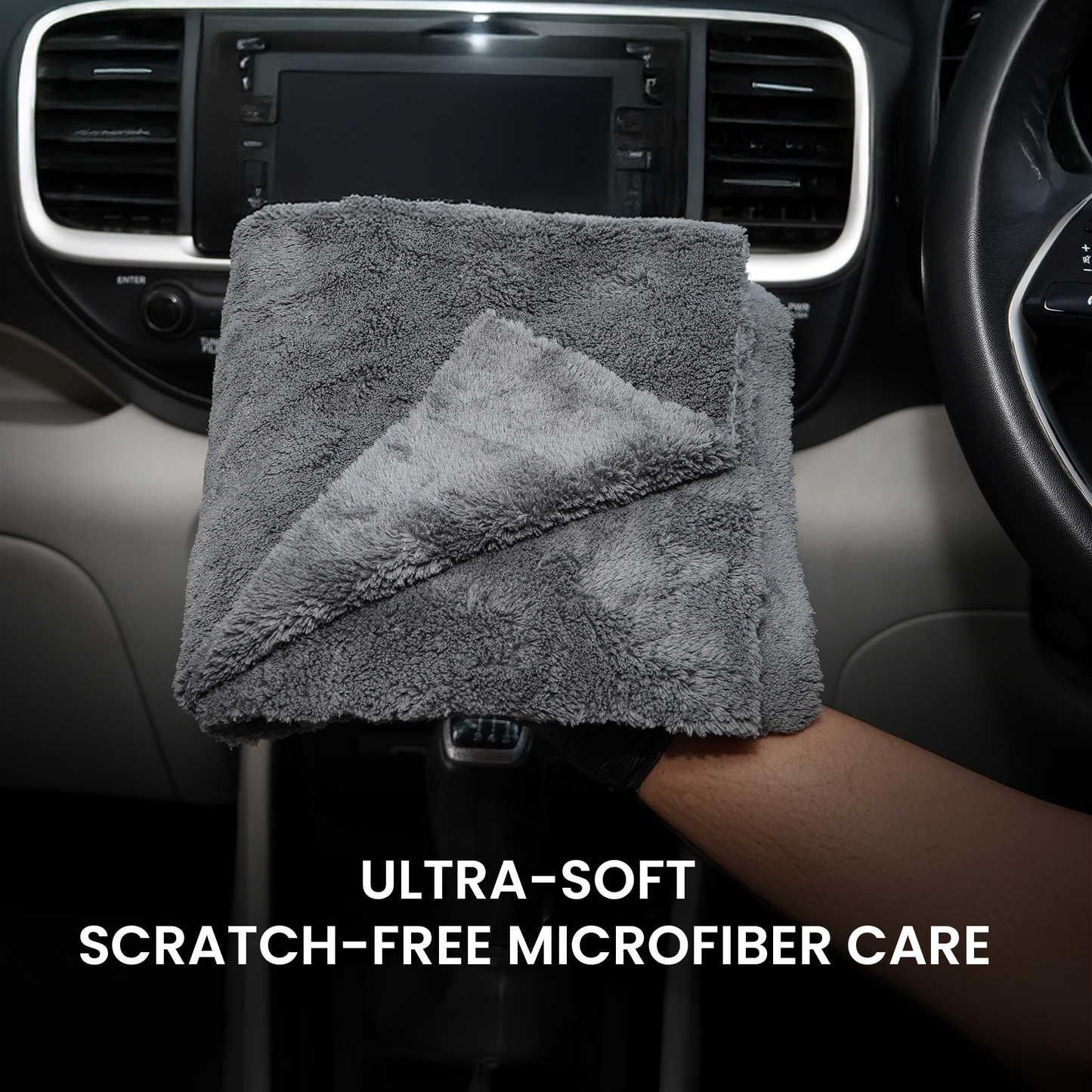 Gray microfiber cloth held by a hand in a car interior with text 'Ultra-Soft Scratch-Free Microfiber Care'.