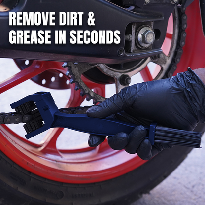 A close-up of a gloved hand using a blue chain cleaning tool on a motorcycle chain near a red wheel, with the text 'REMOVE DIRT & GREASE IN SECONDS' overlaid at the top.